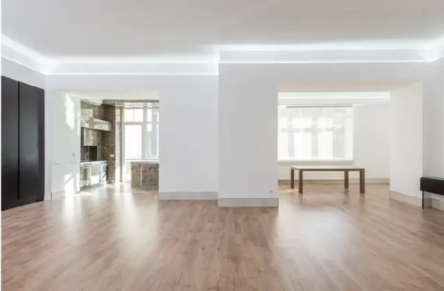 Open floor plan living space in a Michigan home with connected kitchen, dining, and living areas