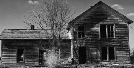 Fire-damaged house in Michigan showing severe structural damage before restoration and insurance assessment